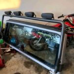 Jeep wrangler TJ Windshield frame with good glass, Hinges, and and a factory light bar with hella lights.
